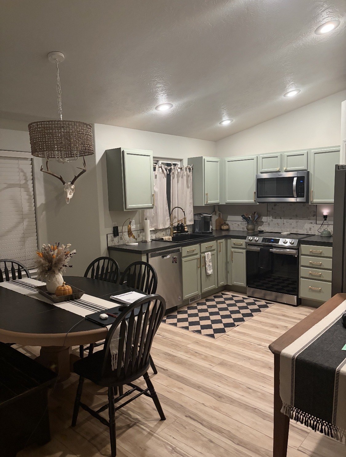 Kitchen and dining area with green cabinetry